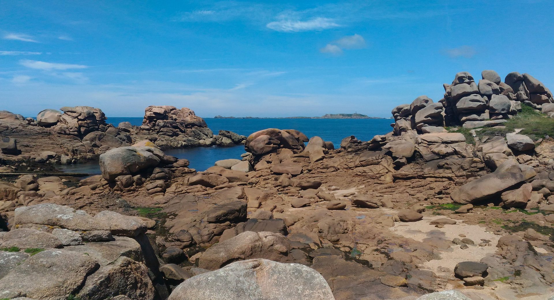 Pink granite boulders and blue sea on the Côte de Granit Rose near Ploumanac’h, Brittany
